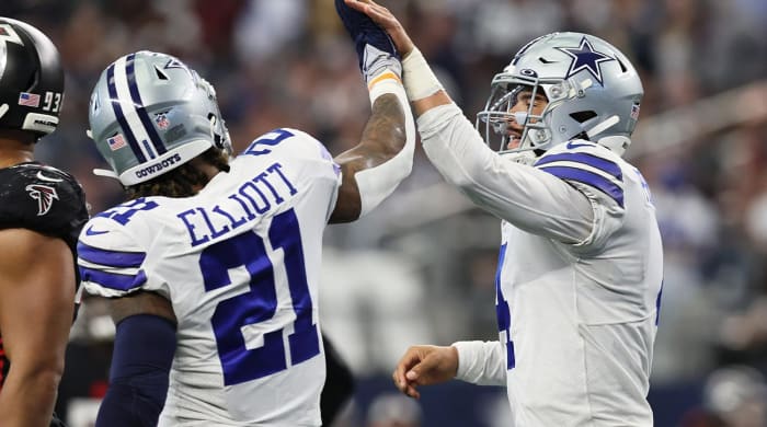 Nov 14, 2021; Arlington, Texas, USA; Dallas Cowboys quarterback Dak Prescott (4) celebrates his third quarter rushing touchdown with running back Ezekiel Elliott (21) against the Atlanta Falcons at AT&T Stadium.